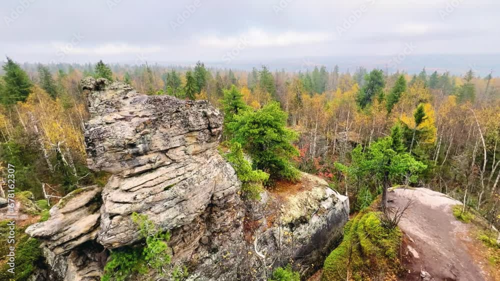 Stone City in autumn. Bright foliage and autumn landscape. The natural landscape is a rock formation in Central Russia, the Urals. A natural monument. Ancient rocky folding in the Ural Mountains. 4K Stone City in autumn. Bright foliage and autumn landscape. The natural landscape is a rock formation in Central Russia, the Urals. A natural monument. Ancient rocky folding in the Ural Mountains. 4K