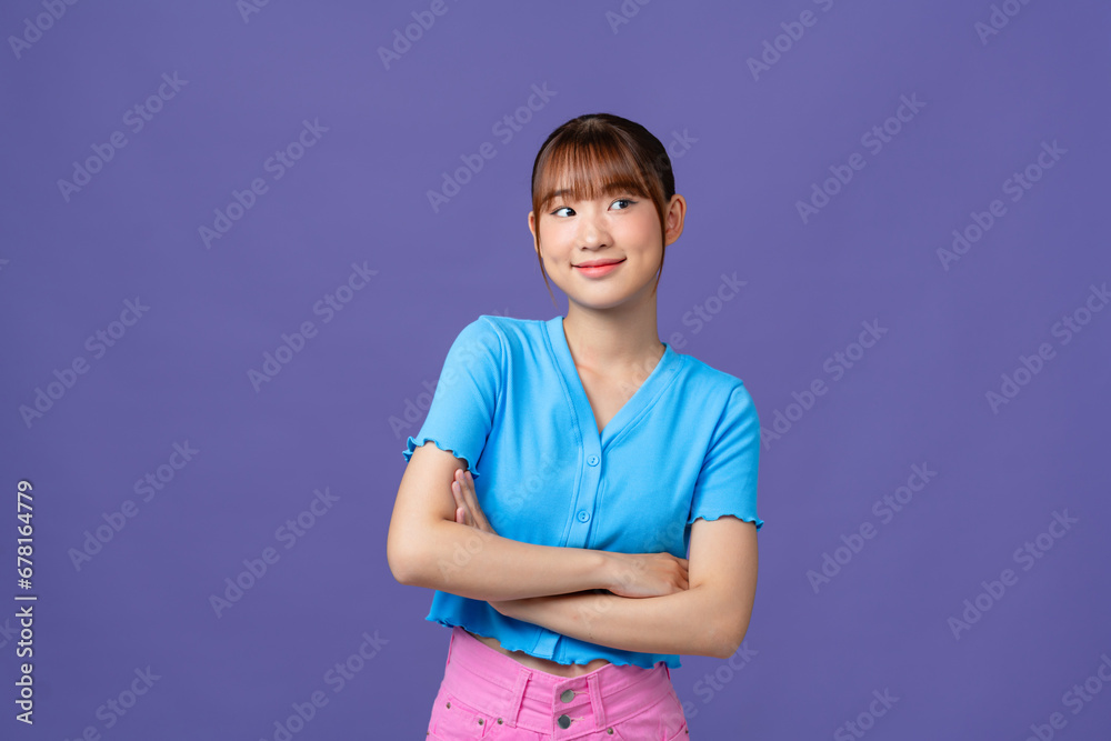 Young asian woman isolated on purple background with arms crossed and happy Young asian woman isolated on purple background with arms crossed and happy