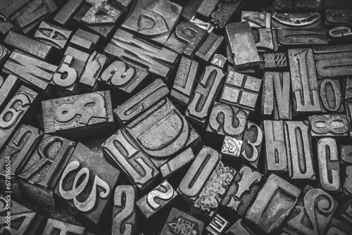 A textured background of old, used, wooden type-setting letter blocks with various fonts, upper- and lowercase, antique letters, all shapes and sizes.  photo