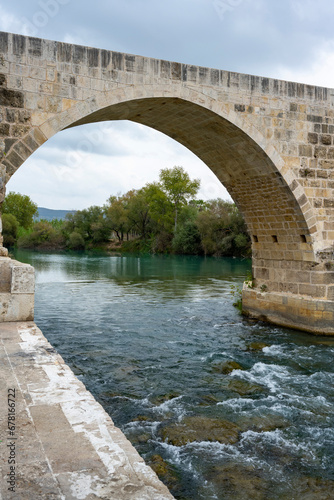 Seljuk bridge in Aspendos. The Eurymedon Bridge. Aspendos Yolu Belkis Mevkii. Turkey. Crooked bridge. Bridge over the Kopruchay (Euremedon) River near Aspendos, in Pamphylia, in southern Anatolia photo