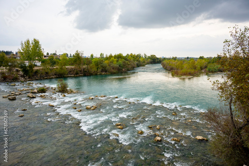 Transparent waters of Kopru River (Köprüçay, ancient Eurymedon) with its emerald green colour in Koprulu Canyon (Köprülü Kanyon) National Park, Antalya, Turkey photo