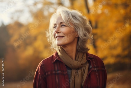 Portrait of a blissful woman in her 50s dressed in a relaxed flannel shirt against a background of autumn leaves. AI Generation