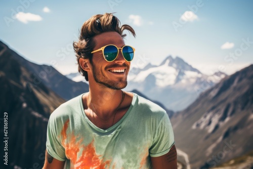 Portrait of a cheerful man in his 20s wearing a trendy sunglasses against a backdrop of mountain peaks. AI Generation © CogniLens