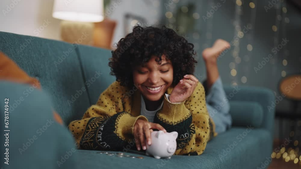 Saving money. Happy African American girl with banking goals finance