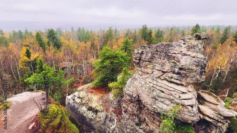 Stone City in autumn. Bright foliage and autumn landscape. The natural landscape is a rock formation in Central Russia, the Urals. A natural monument. Ancient rocky folding in the Ural Mountains. 4K Stone City in autumn. Bright foliage and autumn landscape. The natural landscape is a rock formation in Central Russia, the Urals. A natural monument. Ancient rocky folding in the Ural Mountains. 4K