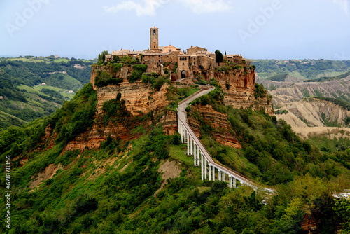 View of the valley and town of Civita di Bagnoregio with stone houses on a high cliff in the province of Viterbo, Lazio region, Italy