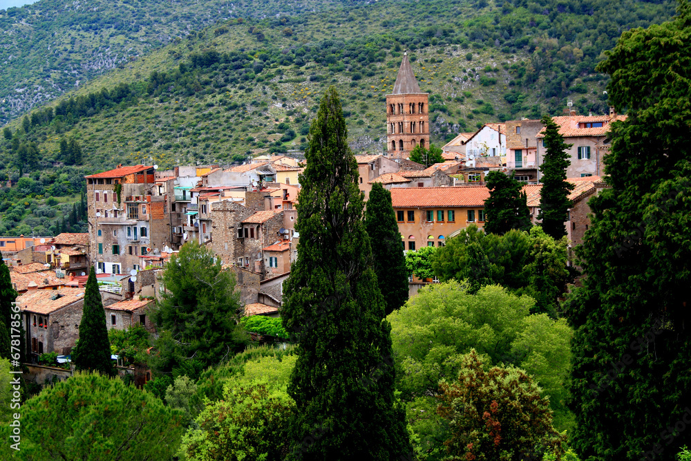 View of the historic part of the city of Tivoli (Italy) with the bell tower of the Cathedral and green hills in the background
