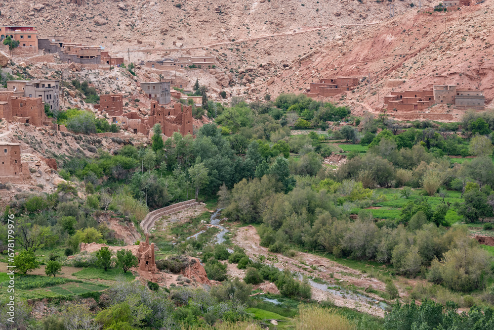 Orange mud villages on the valley of a river in the Atlas Mountains in North Africa