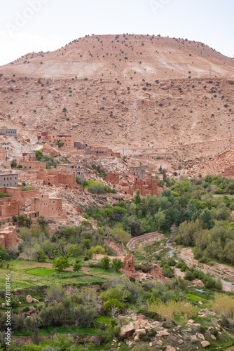 Orange mud villages on the valley of a river in the Atlas Mountains in North Africa