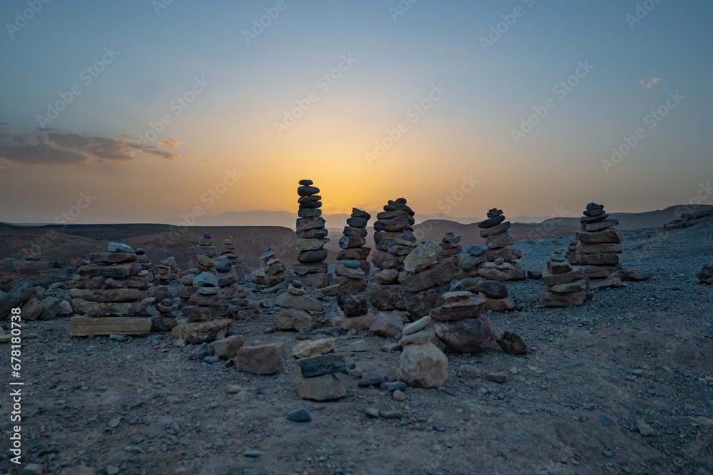 Stack of stone piled up on a hill in the Sahara Desert next to Ait Benhaddou during sunset