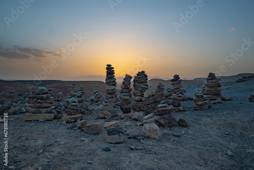 Stack of stone piled up on a hill in the Sahara Desert next to Ait Benhaddou during sunset