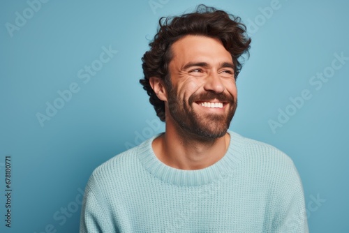Portrait of a happy man in his 30s wearing a cozy sweater against a pastel blue background. AI Generation