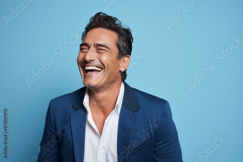 Portrait of a smiling man in his 40s sporting a stylish leather blazer against a pastel blue background. AI Generation