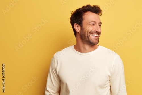 Portrait of a joyful man in his 30s sporting a long-sleeved thermal undershirt against a pastel yellow background. AI Generation