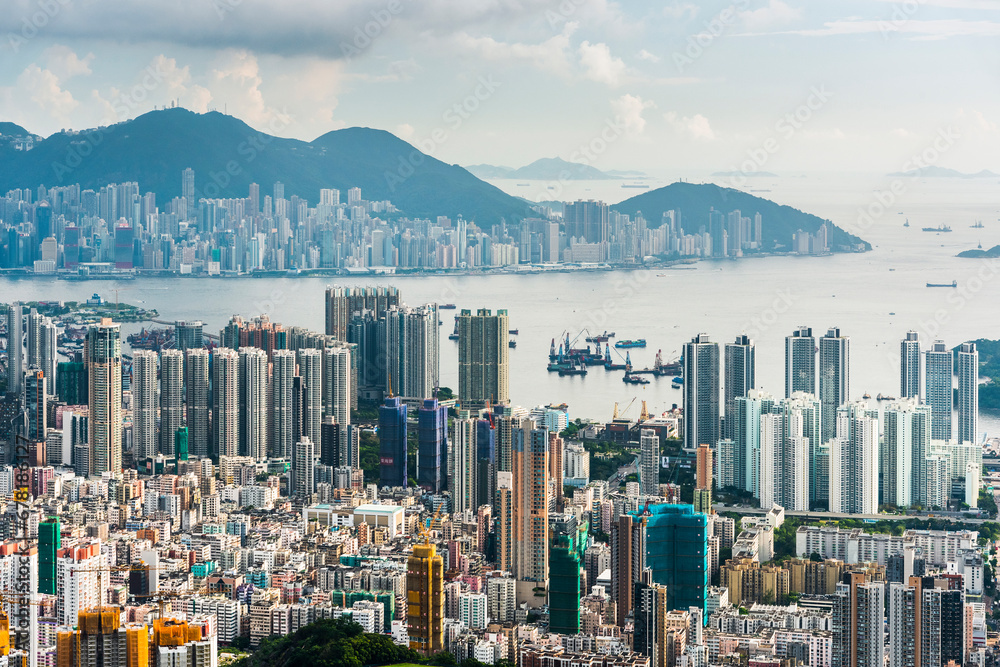 Panorama aerial view of Hong Kong Kowloon's crowded buildings and Victoria Harbour in China.