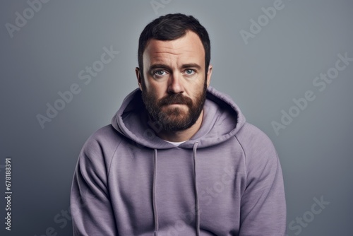 Portrait of a glad man in his 30s sporting a comfortable hoodie against a pastel gray background. AI Generation