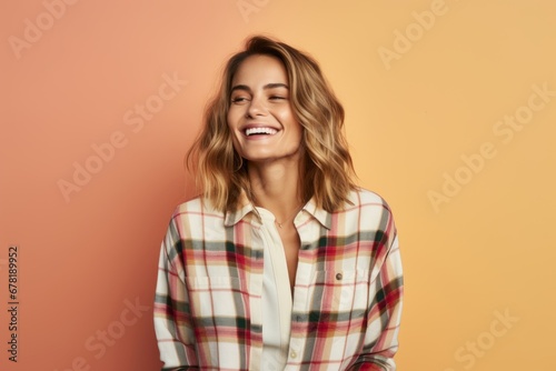 Portrait of a joyful woman in her 30s wearing a comfy flannel shirt against a soft multicolor background. AI Generation