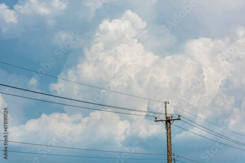 View of Telephone poles with blue sky and white clouds as a background