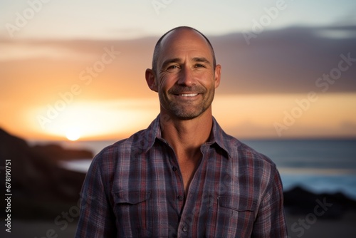 Portrait of a jovial man in his 40s sporting a versatile denim shirt against a stunning sunset beach background. AI Generation © CogniLens
