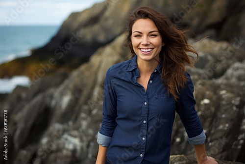 Portrait of a joyful woman in her 30s sporting a versatile denim shirt against a rocky shoreline background. AI Generation photo