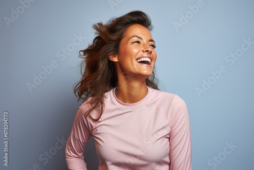 Portrait of a joyful woman in her 30s sporting a breathable mesh jersey against a pastel or soft colors background. AI Generation