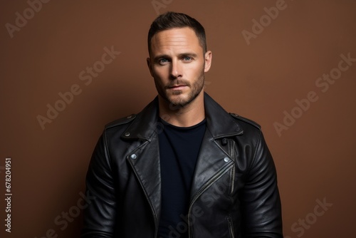 Portrait of a satisfied man in his 30s sporting a classic leather jacket against a pastel or soft colors background. AI Generation