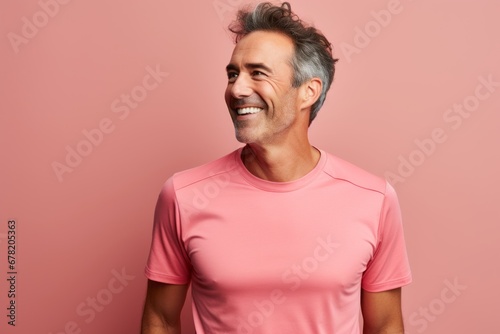 Portrait of a happy man in his 40s wearing a moisture-wicking running shirt against a pastel or soft colors background. AI Generation © CogniLens