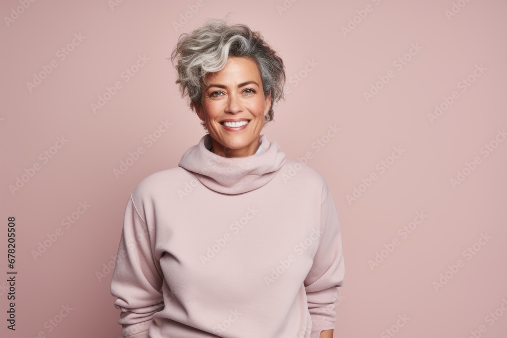 Portrait of a merry woman in her 50s dressed in a comfy fleece pullover against a pastel or soft colors background. AI Generation Portrait of a merry woman in her 50s dressed in a comfy fleece pullover against a pastel or soft colors background. AI Generation