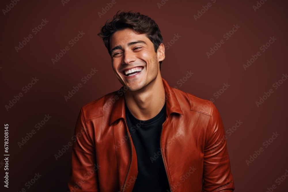 Portrait of a smiling man in his 20s sporting a stylish leather blazer against a solid color backdrop. AI Generation