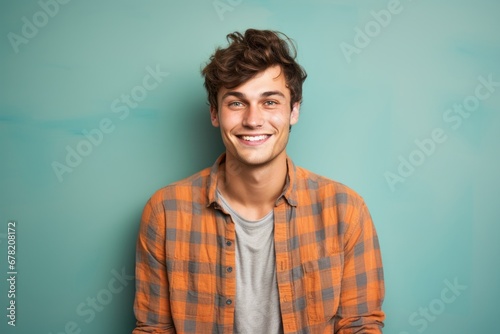 Portrait of a happy man in his 20s dressed in a relaxed flannel shirt against a solid color backdrop. AI Generation © CogniLens