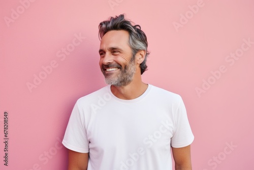 Portrait of a happy man in his 40s sporting a vintage band t-shirt against a solid pastel color wall. AI Generation © CogniLens