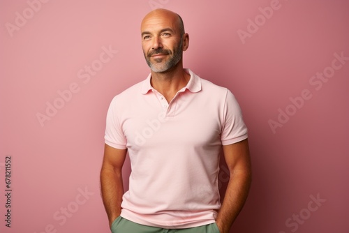 Portrait of a grinning man in his 40s wearing a sporty polo shirt against a solid pastel color wall. AI Generation