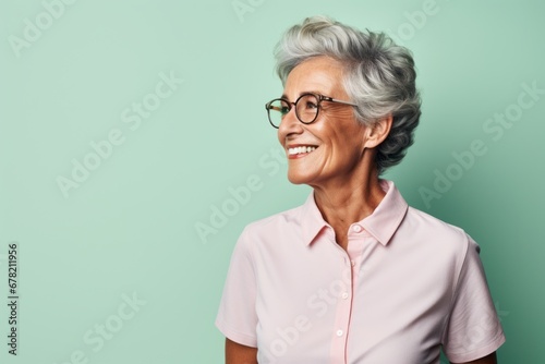 Portrait of a joyful man in his 80s donning a classy polo shirt against a solid pastel color wall. AI Generation