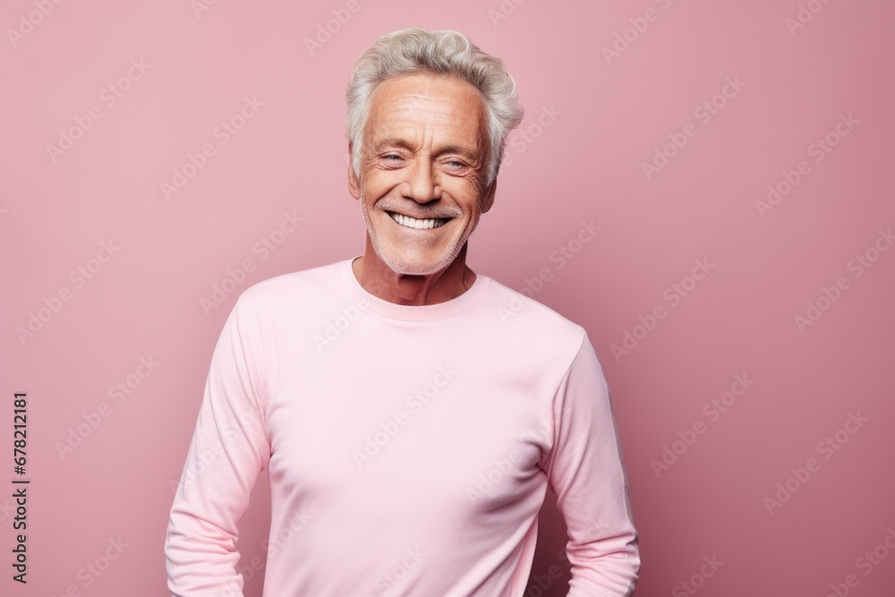 Portrait of a joyful man in his 70s sporting a long-sleeved thermal undershirt against a solid pastel color wall. AI Generation