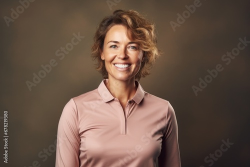 Portrait of a grinning woman in her 40s wearing a breathable golf polo against a plain cyclorama studio wall. AI Generation