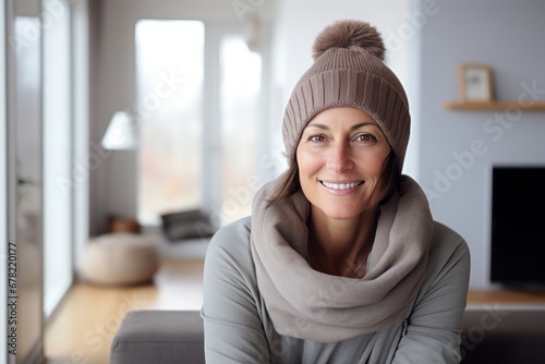 Portrait of a smiling woman in her 40s dressed in a warm ski hat against a crisp minimalistic living room. AI Generation photo