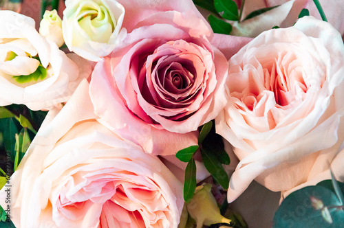 Bouquet of rosebuds with delicate shades of pink, beige and green petals close-up for greeting card.