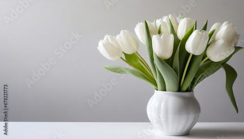 White tulips in a white vase, with a white background