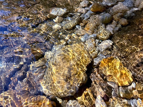 Underwater stones pebbles at the bottom. 