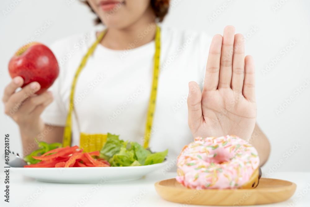 Diet and dieting. Beauty slim female body confuse donut. Woman in exercise clothes achieves weight loss goal for healthy life, crazy about thinness, thin waist, nutritionist.. Diet and dieting. Beauty slim female body confuse donut. Woman in exercise clothes achieves weight loss goal for healthy life, crazy about thinness, thin waist, nutritionist..