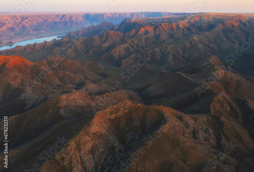 Steppe mountains near the big Ili river in Kazakhstan, view from top at sunset