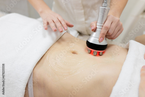 Photography RF body cavitation lifting procedure in a beauty salon