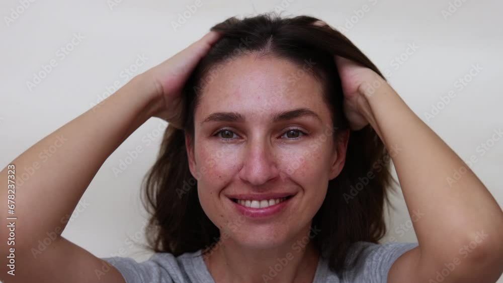 millennial woman brushing hair with eco wooden comb,smiling girl happy to have healthy hair.hand in surgical glove analyzing scalp without dandruff.female looking in double side mirror,holding elastic millennial woman brushing hair with eco wooden comb,smiling girl happy to have healthy hair.hand in surgical glove analyzing scalp without dandruff.female looking in double side mirror,holding elastic