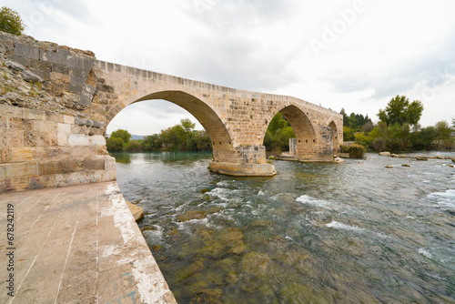 Seljuk bridge in Aspendos. The Eurymedon Bridge. Aspendos Yolu Belkis Mevkii. Turkey. Crooked bridge. Bridge over the Kopruchay (Euremedon) River near Aspendos, in Pamphylia, in southern Anatolia