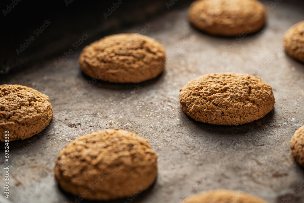 Oatmeal cookies on baking sheet. Fresh sweet pastries for tea. Homemade oatmeal sweets.