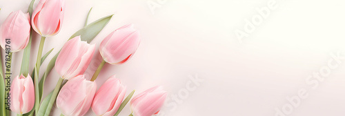 Lovely pastel pink tulips bunch, floral border at light stone background, top view. Layout for springtime holidays. Mother's Valentines day greeting card. Blank copy space for text. Generative AI.