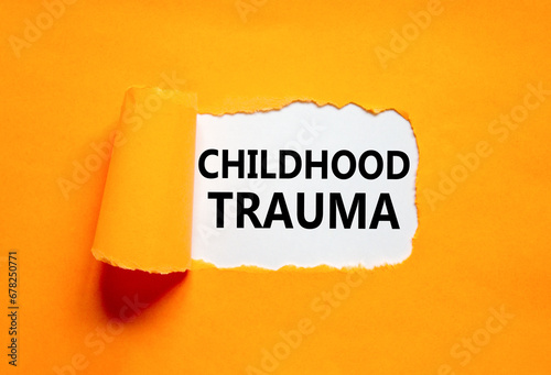 Childhood trauma symbol. Concept words Childhood trauma on beautiful white paper. Beautiful orange paper background. Business psychology childhood trauma concept. Copy space.