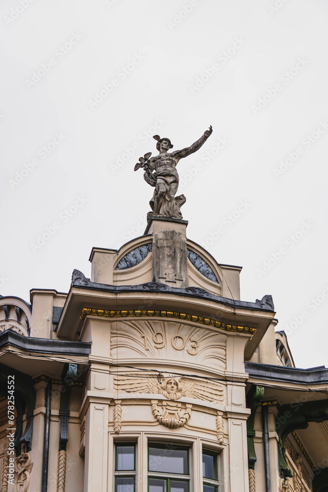 detail of the facade of an important old building with statue with hand extended 