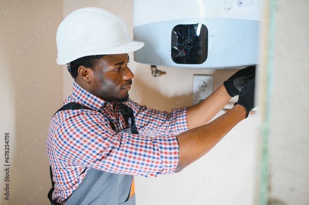 African american worker set up central gas heating boiler at home African american worker set up central gas heating boiler at home