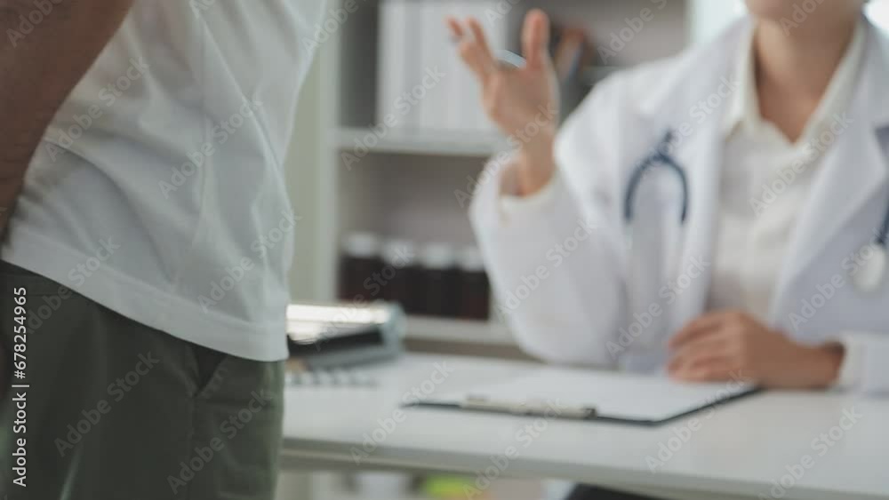 Doctor prescribes treatment to patient with bowel problems and model of unhealthy lower rectum